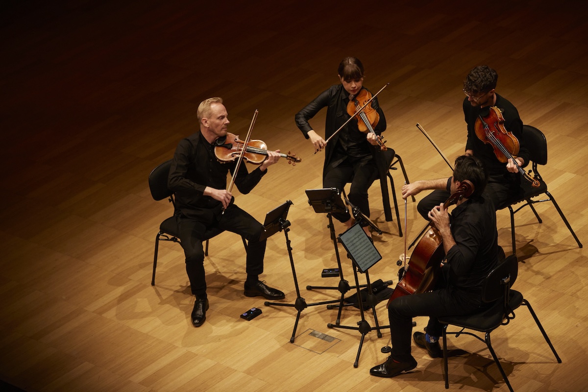 The Australian String Quartet performing live on stage with violins, viola, and cello.